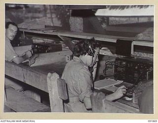 LAE, NEW GUINEA, 1945-05-16. SIGNALWOMAN L. OLIVER, WIRELESS OPERATOR (1), WORKING IN THE WIRELESS ROOM, SIGNALS, HEADQUARTERS FIRST ARMY. AUSTRALIAN WOMEN'S ARMY SERVICE PERSONNEL ARE TAKING OVER ..