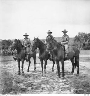 POM POM VALLEY, NEW GUINEA. 1943-11-30. THE COMMANDING OFFICER, SECOND IN CHARGE AND THE ADJUTANT WATCHING THE PARADE OF THE 2/12TH AUSTRALIAN INFANTRY BATTALION. IDENTIFIED PERSONNEL ARE: QX6008 ..