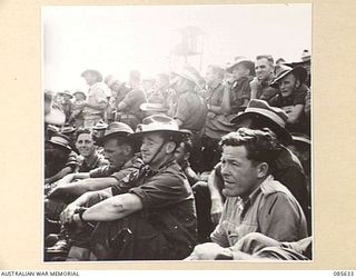 WONDECLA, QLD. 1945-01-19. PRIVATE J WOODS (1), AMONG SPECTATORS AT HQ 9 DIVISION WATCHING EVENTS DURING THE 9 DIV GYMKHANA AT HERBERTON RACECOURSE
