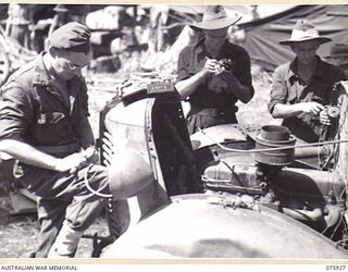 HANSA BAY, NEW GUINEA. 1944-09-07. MECHANICS OF THE 241ST LIGHT AID DETACHMENT, 7TH INFANTRY BRIGADE WORKING ON A CAPTURED JAPANESE TRUCK AT HEADQUARTERS, B COMPANY, 25TH INFANTRY BATTALION, AT ..