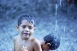 Kids playing in freshwater run-off during downpour
