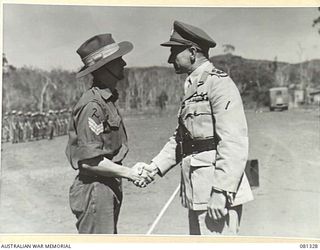 HERBERTON, QLD. 1944-10-11. VX17 MAJOR GENERAL J.E.S. STEVENS, DSO, ED, GOC 6TH DIVISION (1) PRESENTS THE ORDER OF PATRIOTIC WAR FIRST CLASS TO NX4050 SERGEANT N.S. MACINTYRE (2). MEMBERS OF THE 2/ ..