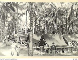 ALEXISHAFEN, NEW GUINEA. 1944-09-13. THE TENT LINES OF THE 133RD BRIGADE WORKSHOPS. IDENTIFIED PERSONNEL ARE:- Q267610 PRIVATE D.A. BARRETT (1); NX87268 PRIVATE R. COOPER (2); VX248 MAJOR S.E. ..