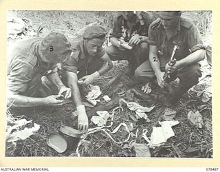BOUGAINVILLE ISLAND. 1945-01-16. TROOPS OF THE FIELD SECURITY SECTION AND THE 47TH INFANTRY BATTALION GOING THROUGH JAPANESE MEDICAL SUPPLIES FOUND IN A CAPTURED JAPANESE PILLBOX ON THE BANK OF THE ..
