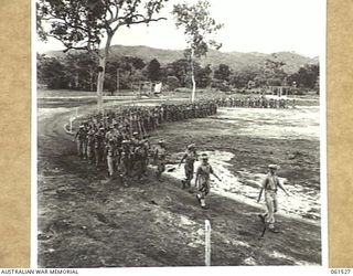 POM POM VALLEY, NEW GUINEA. 1943-11-30. 2/12TH AUSTRALIAN INFANTRY BATTALION, MARCHING OFF THE SHOWGROUND AFTER AN INSPECTION BY THEIR COMMANDING OFFICER, QX6008 LIEUTENANT COLONEL C. C. F. BOURNE. ..