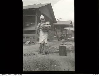 VIVIGANI, GOODENOUGH ISLAND, PAPUA NEW GUINEA. C. 1943-07. 13205 LEADING AIRCRAFTMAN A. H. HALL OF MOOROOPNA, VIC, BAKER OF NO. 7 MOBILE WORKS SQUADRON RAAF, WITH THE DAILY BREAD FOR THE UNIT