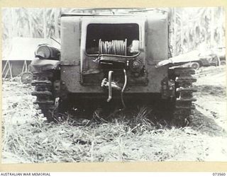 MADANG - ALEXISHAFEN ROAD, NEW GUINEA. 1944-05-26. THE REAR VIEW OF A JAPANESE ARMOURED TRACTOR (POWERED) ABANDONED ON THE ROAD NEAR MILILAT PLANTATION. DESIGNED TO SEAT APPROXIMATELY 7 PEOPLE, IT ..