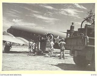 1942-12-02. NEW GUINEA. HOSPITAL EQUIPMENT BEING LOADED INTO A TRANSPORT PLANE IN WHICH IT WILL BE FLOWN TO AN ADVANCED BASE WHERE WOUNDED WILL BE TREATED WHILST AWAITING TRANSPORT. (NEGATIVE BY G. ..