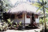 French Polynesia, women sitting on steps of home on Tahiti Island