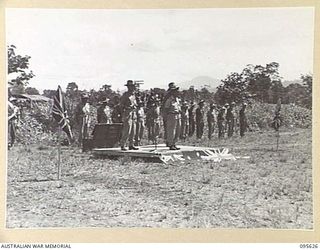LAE AREA, NEW GUINEA. 1945-09-01. COLONEL J.T. SIMPSON, DEPUTY DIRECTOR OF ORDNANCE SERVICE AT THE SALUTING BASE DURING A PARADE OF THE ORDNANCE PERSONNEL UNDER HIS COMMAND IN THE LAE AREA. THE ..