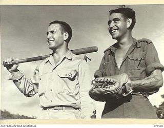 PORT MORESBY, PAPUA, 1944-02. PRIVATE HENRY LINDSAY, (1), AN AUSTRALIAN SOLDIER VIEWS SOFTBALL WITH AN AMERICAN SERVICEMAN, CORPORAL SOL SKLAR, OF NEW YORK CITY, (2), AT A UNITED STATES HOSPITAL IN ..