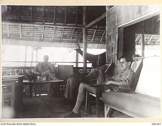 HOMBU HOMBU, NEW GEORGIA ISLAND. 1945-03-28. PERSONNEL OF THE BRITISH SOLOMON ISLANDS DEFENCE FORCE AT THE BRITISH RESIDENCE, WHICH CONTROLS THE NATIVE LABOUR CORPS AND MAINTAINS NATIVE PATROLS. ..