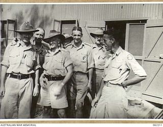 PORT MORESBY, PAPUA, NEW GUINEA. 1943-10-31. SOME OF THE OFFICERS ATTENDING A STAFF COURSE AT HEADQUARTERS, NEW GUINEA FORCE, OUTSIDE THE SIGNAL TERMINAL OF THE PORT MORESBY-DOBODURA LAND LINE. ..