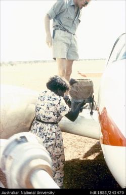 Man standing on plane wing