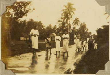 Parents and children on a wet road in Tonga, 1928