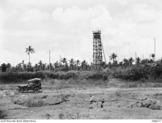 TOBERA AIRSTRIP, NEW BRITAIN. 1945-11-01. A GENERAL VIEW OF THE AIRSTRIP SHOWING THE CONTROL TOWER AND BOMB CRATERS ON THE RUNWAY