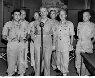 LAE, NEW GUINEA, 1945-12-25. THE RIGHT HONOURABLE J. B. CHIFLEY, PRIME MINISTER OF AUSTRALIA (2) AND MEMBERS OF HIS PARTY IN THE STUDIOS AT AUSTRALIAN ARMY AMENITIES SERVICES BROADCASTING STATION ..