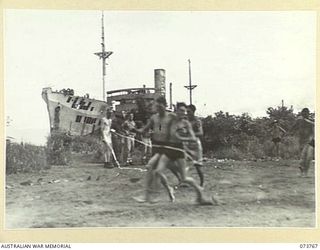 LAE, NEW GUINEA. 1944-06-08. COMPETITORS IN A THREE-LEGGED RACE ACROSS THE FINISHING LINE DURING THE SPORTS CARNIVAL HELD ON VOCO BEACH BY MEMBERS OF THE 2/7TH ADVANCED WORKSHOP. THE CARNIVAL IS ..