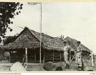 LAE, NEW GUINEA. 1944-04-01. LIEUTENANT (SP) I.F.C. FRANICK (1), (CYPHER OFFICER), ROYAL AUSTRALIAN NAVAL VOLUNTEER RESERVE, WITH LIEUTENANT (SP) E. NASH (2), (INTELLIGENCE OFFICER), RANVR, OUTSIDE ..