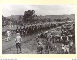 RABAUL, NEW BRITAIN. 1945-10-11. A PARADE OF THE ROYAL PAPUAN CONSTABULARY MOVING DOWN MALAGUNA ROAD DURING THE MARCH PAST. THE SALUTE WAS TAKEN BY MAJOR GENERAL K.W. EATHER, GENERAL OFFICER ..
