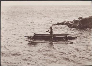 Boy in canoe off the coast of Merelava, Banks Islands, 1906 / J.W. Beattie