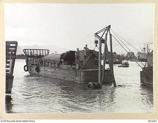 PURUATA ISLAND, SOUTH BOUGAINVILLE. 1945-05-29. A 42 LANDING CRAFT COMPANY BARGE FLOATS CLEAR OF A LE TOURNEAU CRANE WHICH HAS PUSHED IT INTO THE WATER