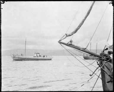 Bowsprit on right of image with two other vessels sailing past, New Guinea, ca. 1929 / Sarah Chinnery