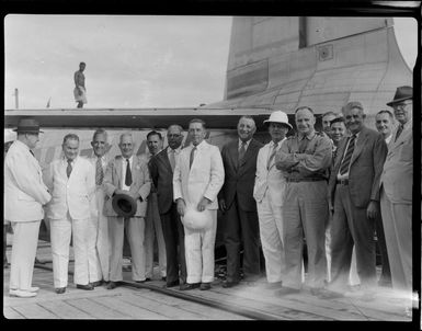 Unidentified group of men standing in front of Tasman Empire Airways flying boat, RMA New Zealand ZK-AME, Fiji