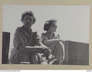 LAE, NEW GUINEA. 1945-05-19. SIGNALWOMEN N.L. EADE (1), AND CORPORAL N.B. AKERS (2), AUSTRALIAN WOMEN'S ARMY SERVICE PERSONNEL, ON THE STERN OF A LAUNCH DURING A TRIP FROM LAE TO SALAMAUA ORGANISED ..