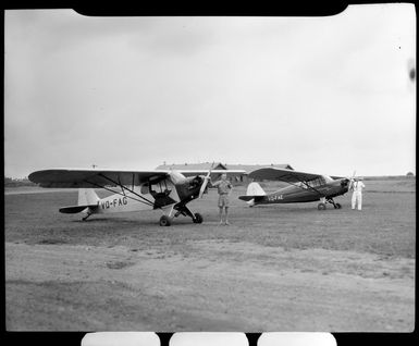 Corporal W Tarr and T French with airplanes at Nausori Airport, Fiji