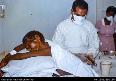 Dr Frank Spooner tapping a client for fluid, Paton Memorial Hospital