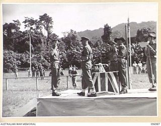TOROKINA, BOUGAINVILLE. 1945-09-24. STAFF SERGEANT JACKSON, 24 INFANTRY BATTALION, SALUTING MAJOR GENERAL W. BRIDGEFORD, GENERAL OFFICER COMMANDING 3 DIVISION, BEFORE BEING PRESENTED WITH HIS ..