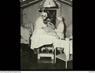 MILNE BAY, PAPUA. C. 1944-02. RAAF NURSING SISTER ROUGET (RIGHT) IN THE OPERATING THEATRE OF NO. 2 MEDICAL CLEARING STATION RAAF