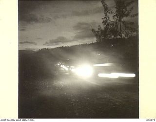 WAU, NEW GUINEA, 1944-02-24. A 44-VEHICLE CONVOY FROM THE 2/34TH GENERAL TRANSPORT COMPANY LEAVING WAU FOR BULLDOG AT 0700 HOURS TO RETURN BY THE REINHOLD HIGHWAY. TRAVELLING AT AN AVERAGE SPEED OF ..