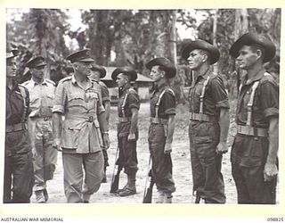 TOROKINA, BOUGAINVILLE. 1945-06-08. LIEUTENANT GENERAL V.A.H. STURDEE, GENERAL OFFICER COMMANDING FIRST ARMY, ACCOMPANIED BY LIEUTENANT G.R.H. GLANVILLE, OFFICER COMMANDING D COMPANY, 2/1 GUARD ..