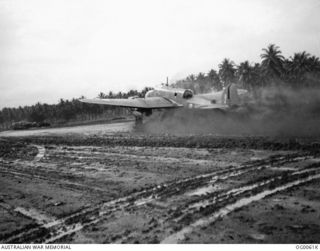 MILNE BAY, PAPUA. C. 1942-10. A BEAUFORT BOMBER AIRCRAFT OF NO. 100 SQUADRON RAAF SENDS UP A SPRAY OF MUD DURING TAKE-OFF FROM GURNEY AIRSTRIP