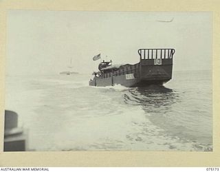 MADANG AREA, NEW GUINEA. 1944-08-09. UNITED STATES ARMY BARGE NO.13 MOVING ALONG IN THE WAKE OF A SISTER SHIP ON THE WAY TO MADANG