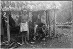 Gunts: smiling men relax under shelter