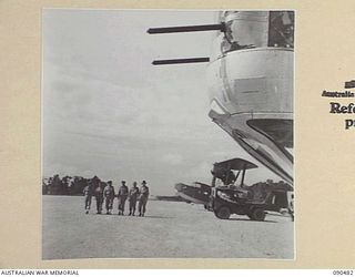 JACQUINOT BAY, NEW BRITAIN. 1945-04-09. SENATOR J.M. FRASER, ACTING MINISTER FOR THE ARMY (1), AND OFFICIAL PARTY, EXAMINING THE AIRSTRIP BUILT FOR THE RAAF BY MEN OF 5 DIVISION