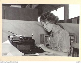 LAE, NEW GUINEA, 1945-05-21. PRIVATE J.S. SMITH, AUSTRALIAN WOMEN'S ARMY SERVICE RECORDING MAIL AT THE AUSTRALIAN ARMY CANTEENS SERVICE, CANTEEN BULK STORE ON BUSU ROAD