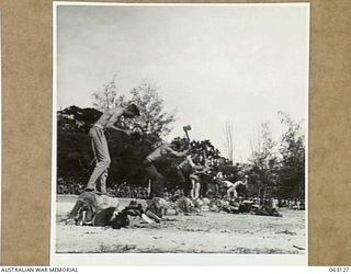 ELA BEACH, NEW GUINEA. 1944-01-01. QX47852 SIGNALMAN G. E. PRIOR, 5TH DIVISION SIGNALS, WINNING THE 12" UNDERHAND WOOD CHOP EVENT AT THE ALLIED SERVICES GRAND SPORTS CARNIVAL