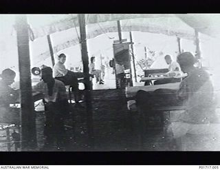 BOOTLESS BATTERY, PORT MORESBY, NEW GUINEA. C.1943. PATIENTS AND STAFF IN THE PHYSIOTHERAPY DEPARTMENT TENT AT 2/5TH AUSTRALIAN GENERAL HOSPITAL