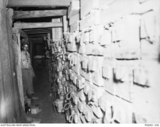 NEW BRITAIN, 1945-09. THE INTERIOR OF A JAPANESE AMMUNITION STORAGE BUNKER IN THE RABAUL AREA. (RNZAF OFFICIAL PHOTOGRAPH.)