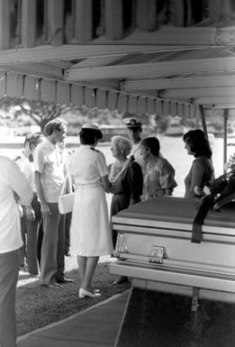 Guests offer condolences to Magdelena Sather at her son's funeral at the National Memorial Cemetery of the Pacific. Lieutenant Junior Grade (LTJG) Richard C. Sather was one of the first American pilots killed in North Vietnam in 1964. After 21 years, his remains were returned to the United States in August 1985 for burial