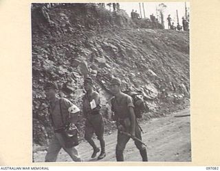 MOUNT SHIBURANGU, WEWAK AREA, NEW GUINEA. 1945-09-21. THE FIRST GROUP OF JAPANESE SOLDIERS FROM 18 JAPANESE ARMY APPROACHING THE ASSEMBLY POINT AT MAKOW ON TOP OF MOUNT SHIBURANGU WHERE THEIR GEAR ..