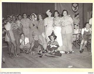 LAE, NEW GUINEA. 1945-11-08. A GROUP OF AUSTRALIAN WOMEN'S ARMY SERVICE PRIZEWINNERS, WITH CAPTAIN HORNSBY (FOURTH FROM LEFT) AT THE FANCY DRESS PARTY HELD BY MEMBERS OF BARRACKS TO FAREWELL ..