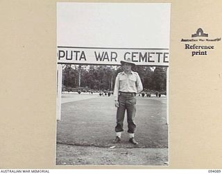 SOPUTA, NEW GUINEA, 1945-06-26. CPL R. TOWNSEND, WHO IS IN CHARGE OF THE SOPUTA WAR CEMETERY, WHICH IS MAINTAINED BY THE AUSTRALIAN WAR GRAVES SERVICE