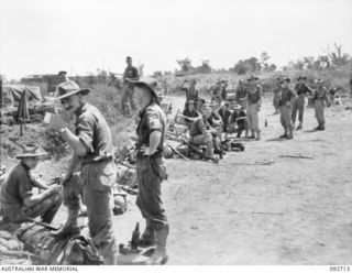 WEWAK AREA, NEW GUINEA, 1945-05-30. MEMBERS OF 2/7 COMMANDO SQUADRON RESTING AT THE ROAD HEAD AT BORAM AIRSTRIP AFTER COMING OUT OF ACTION IN THE HILLS. THIS ACTION CULMINATED IN THE CAPTURE OF ..