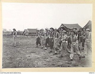 CAPE WOM, WEWAK AREA, NEW GUINEA. 1945-09-05. EACH DAY HEADQUARTERS SECTION, 6 DIVISION PROVOST COMPANY, PARADE FOR THE PURPOSE OF ADMINISTRATION AND HAVE THEIR DUTIES LISTED. THE MEN ARE SEEN ..