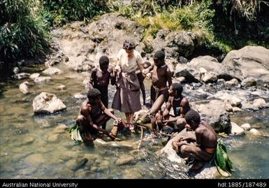 Pat being helped across a creek